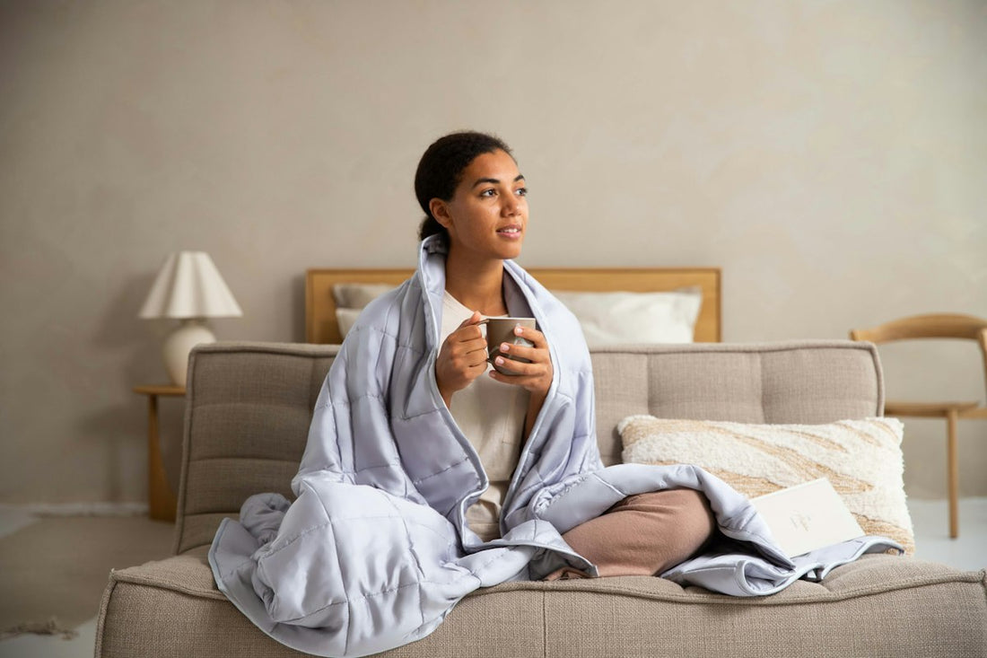 A woman resting on a cozy couch holding a warm cup of coffee